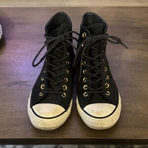 Stylish Black High-Top Sneakers with Gold Accents